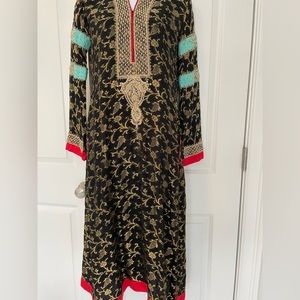Black jamawar kameez with silk gharara pants. Embroidery on sleeves